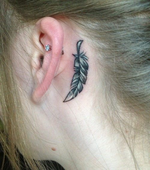 Black Ans White Feather Tattoo On Girl Left Behind The Ear
