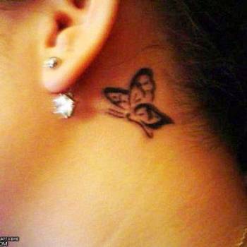 Black Butterfly Tattoo On Left Behind The Ear