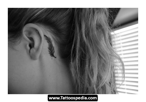 Black Feather Tattoo On Girl Left Behind The Ear