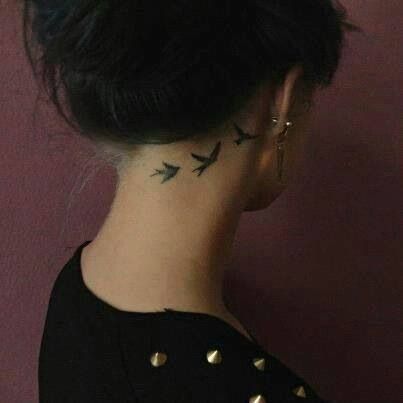 Black Flying Birds Tattoo On Girl Right Behind The Ear