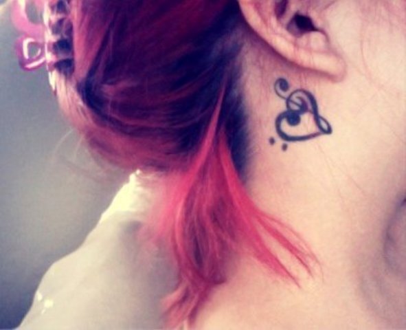 Black Heart Treble Clef Tattoo On Girl Right Behind The Ear