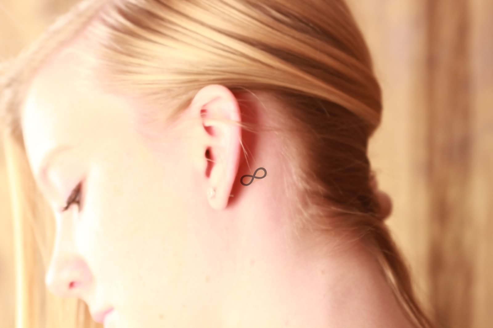 Black Infinity Tattoo On Girl Left Behind The Ear
