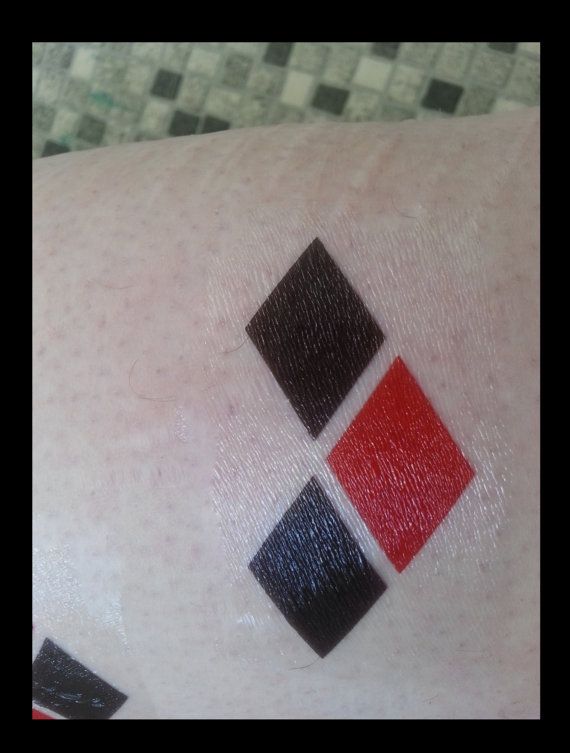 Black Ink And Red Harley Quinn Symbol Tattoo