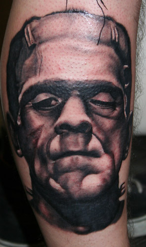 Black Ink Frankenstein Head Tattoo Design For Leg Calf