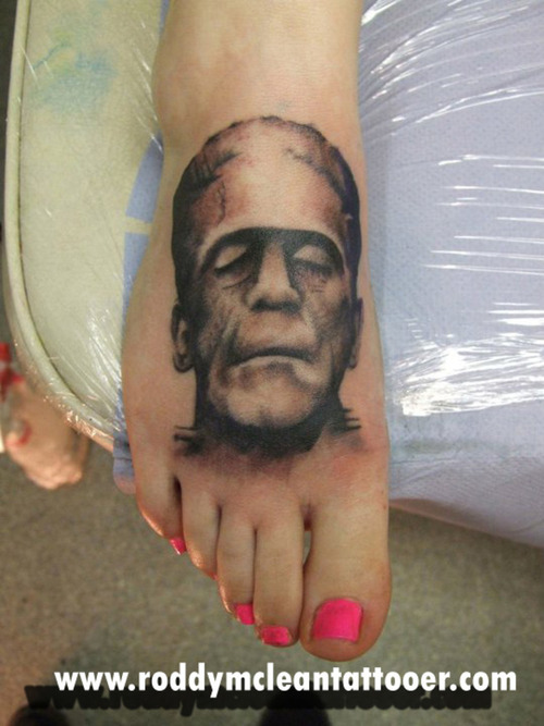 Black Ink Frankenstein Head Tattoo On Girl Right Foot