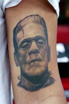 Black Ink Frankenstein Head Tattoo On Left Half Sleeve