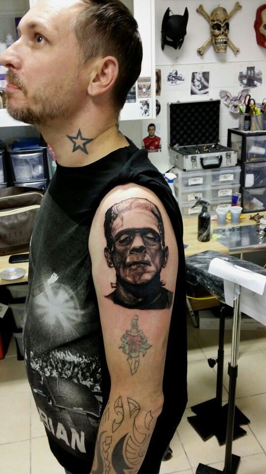 Black Ink Frankenstein Head Tattoo On Man Left Shoulder