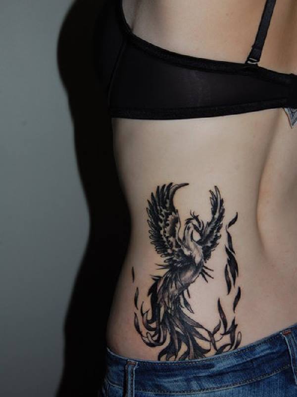 Black Ink Phoenix Tattoo On Lower Back