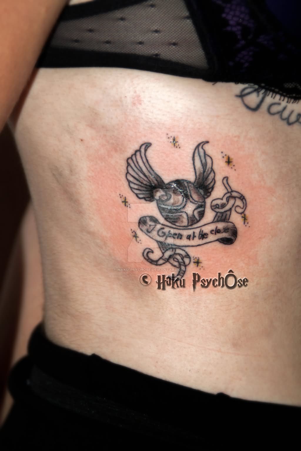 Black Ink Snitch With Banner Tattoo On Girl Side Rib By Haku Psychose