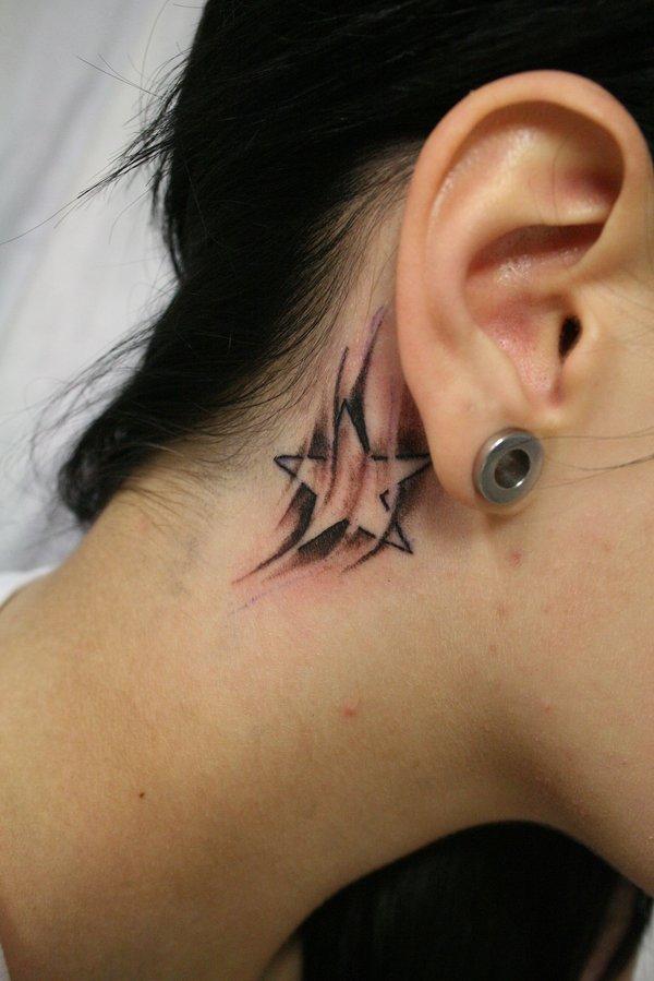 Black Ink Star Tattoo On Girl Right Behind The Ear