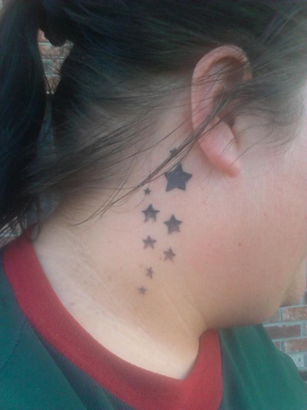 Black Ink Stars Tattoo On Girl Right Behind The Ear