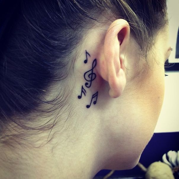 Black Music Knots Tattoo On Girl Right Behind The Ear