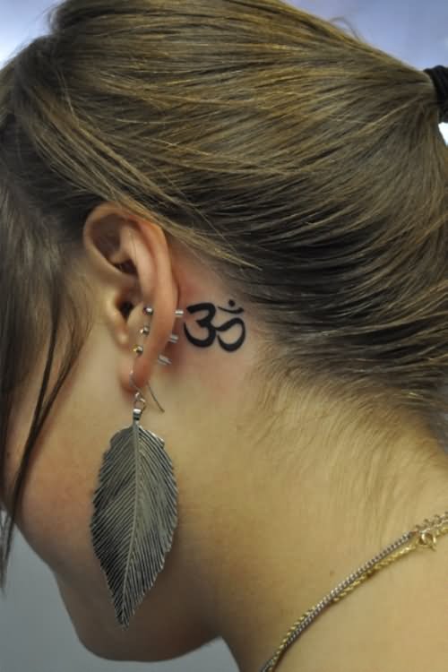 Black Om Tattoo On Girl Left Behind The Ear