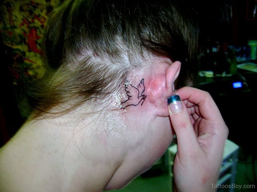 Black Outline Bird Tattoo On Girl Right Behind The Ear