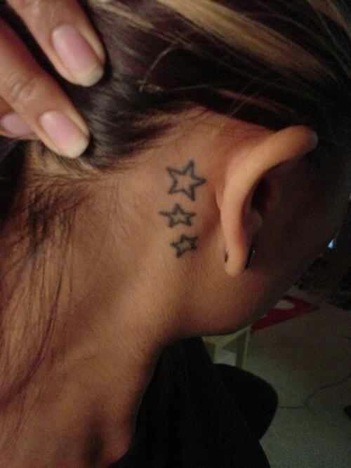 Black Outline Stars Tattoo On Girl Right Behind The Ear