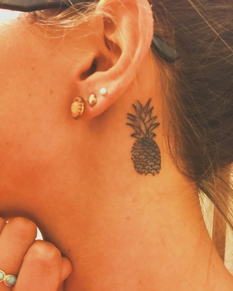 Black Pineapple Tattoo On Girl Left Behind The Ear