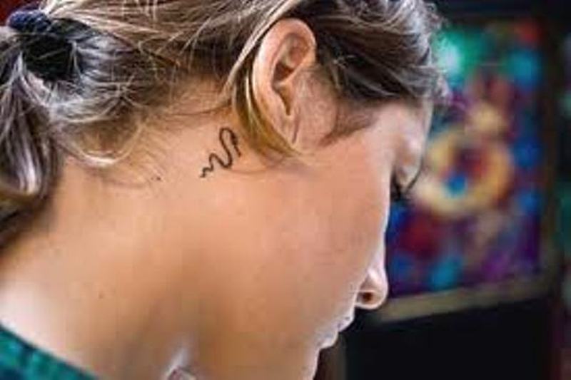Black Snake Tattoo On Girl Right Behind The Ear