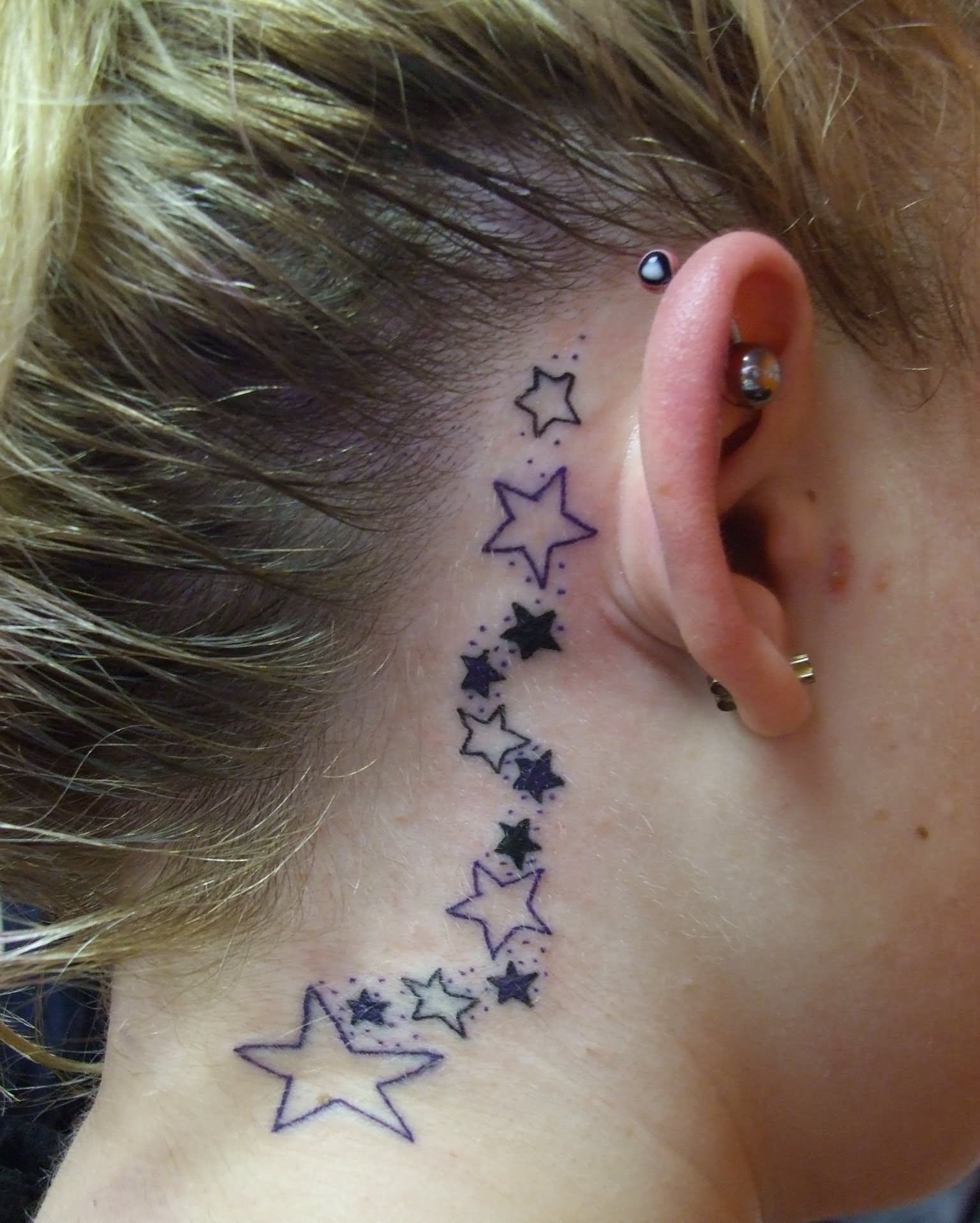Black Stars Tattoo On Girl Right Behind The Ear