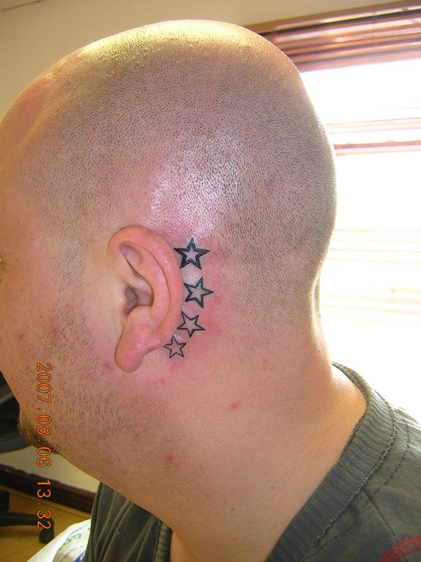 Black Stars Tattoo On Man Left Behind The Ear