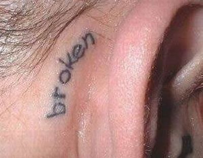 Broken Word Tattoo On Right Behind The Ear