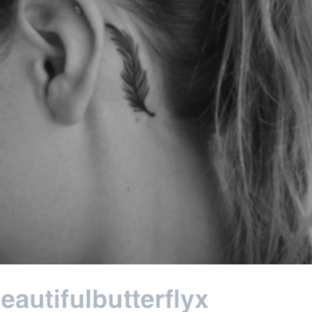 Classic Feather Tattoo On Left Behind The Ear