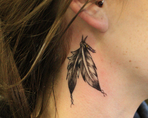 Cool Black Ink Feathers Tattoo On Right Behind The Ear