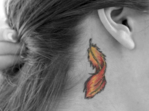 Cool Feather Tattoo On Girl Right Behind The Ear