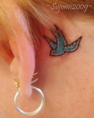 Cool Flying Bird Tattoo On Left Behind The Ear