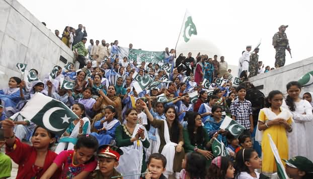 Crowd Waving Pakistani Flag Celebrating Independence Day Of Pakistan