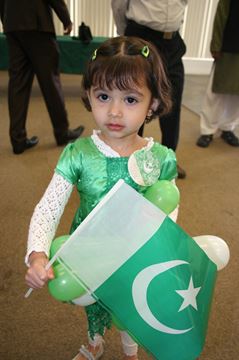 Cute Little Pakistani Girl With Flag Celebrating Independence Day