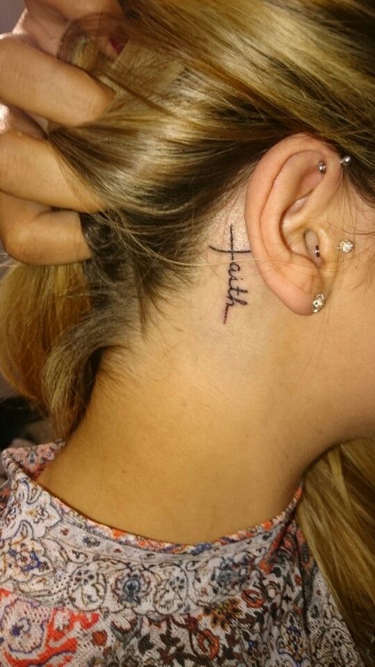 Faith Lettering Tattoo On Girl Right Behind The Ear
