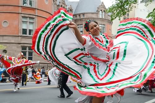 Girl Wearing Mexican Flag Dress Dancing During The Cinco de Mayo Celebrations