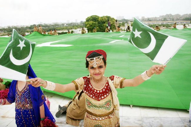 Girl With Pakistani Flag In Hand Celebrating Independence Day Of Pakistan