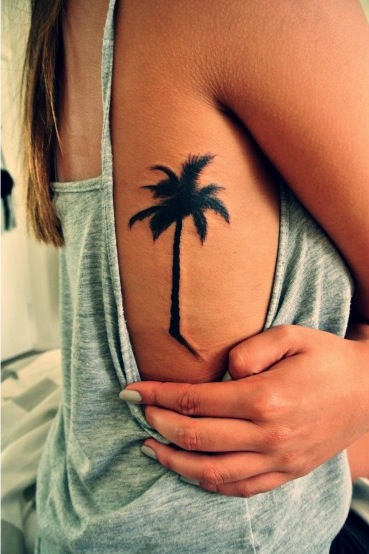 Girl With Palm Tree Tattoo On Rib Side