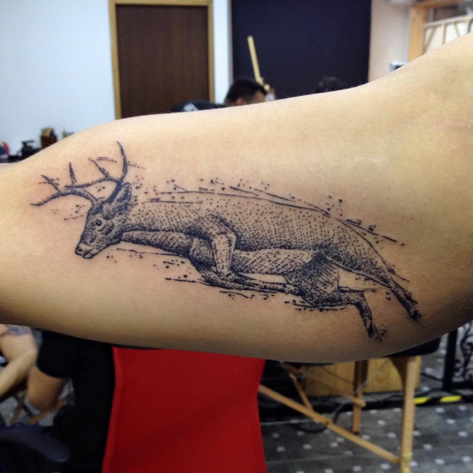 Grey Ink Dotwork Running Deer Tattoo On Inner Bicep by Daniel Rozo