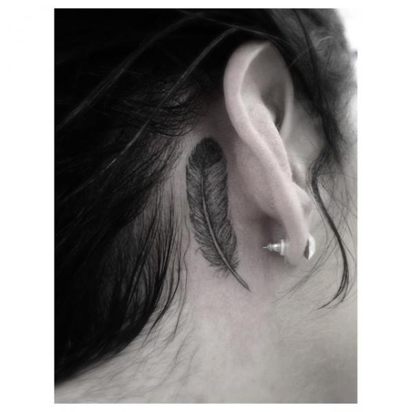 Grey Ink Feather Tattoo On Girl Right Behind The Ear By Dr Woo