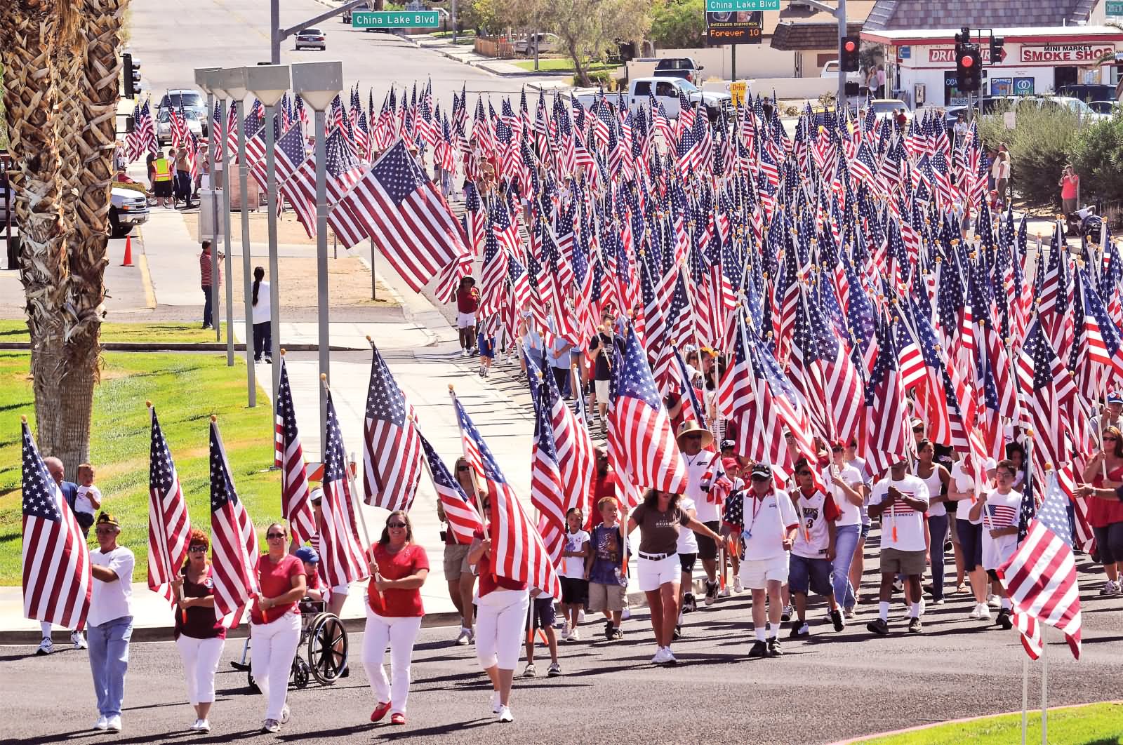 Large Number Of People With American Flags Participating In Flag Day Parade