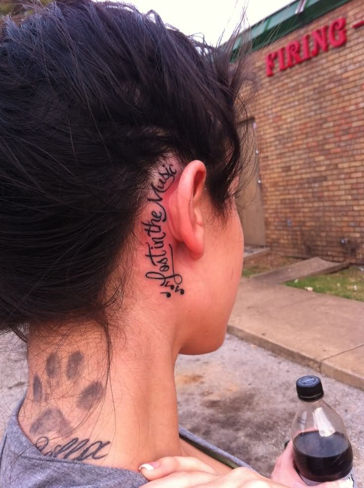 Lost In The Music Words Tattoo On Girl Right Behind The Ear
