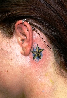 Nautical Star Tattoo On Left Behind The Ear