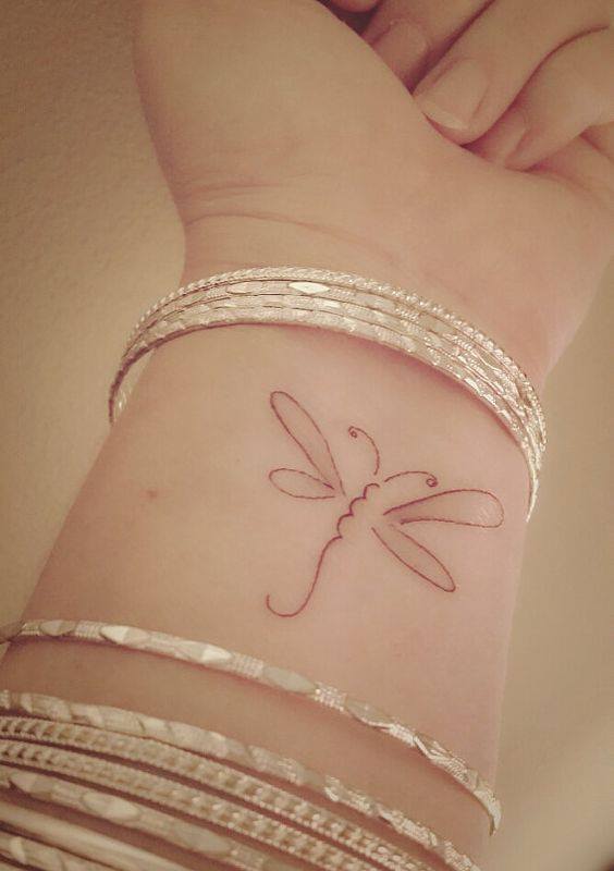 Outline Dragonfly Tattoo On Left Wrist