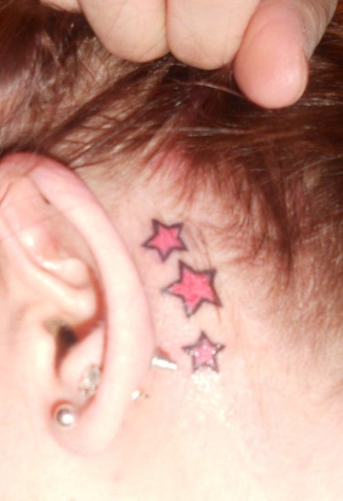 Pink Ink Stars Tattoo On Left Behind The Ear
