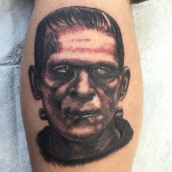 Simple Black Ink Frankenstein Head Tattoo Design For Leg Calf