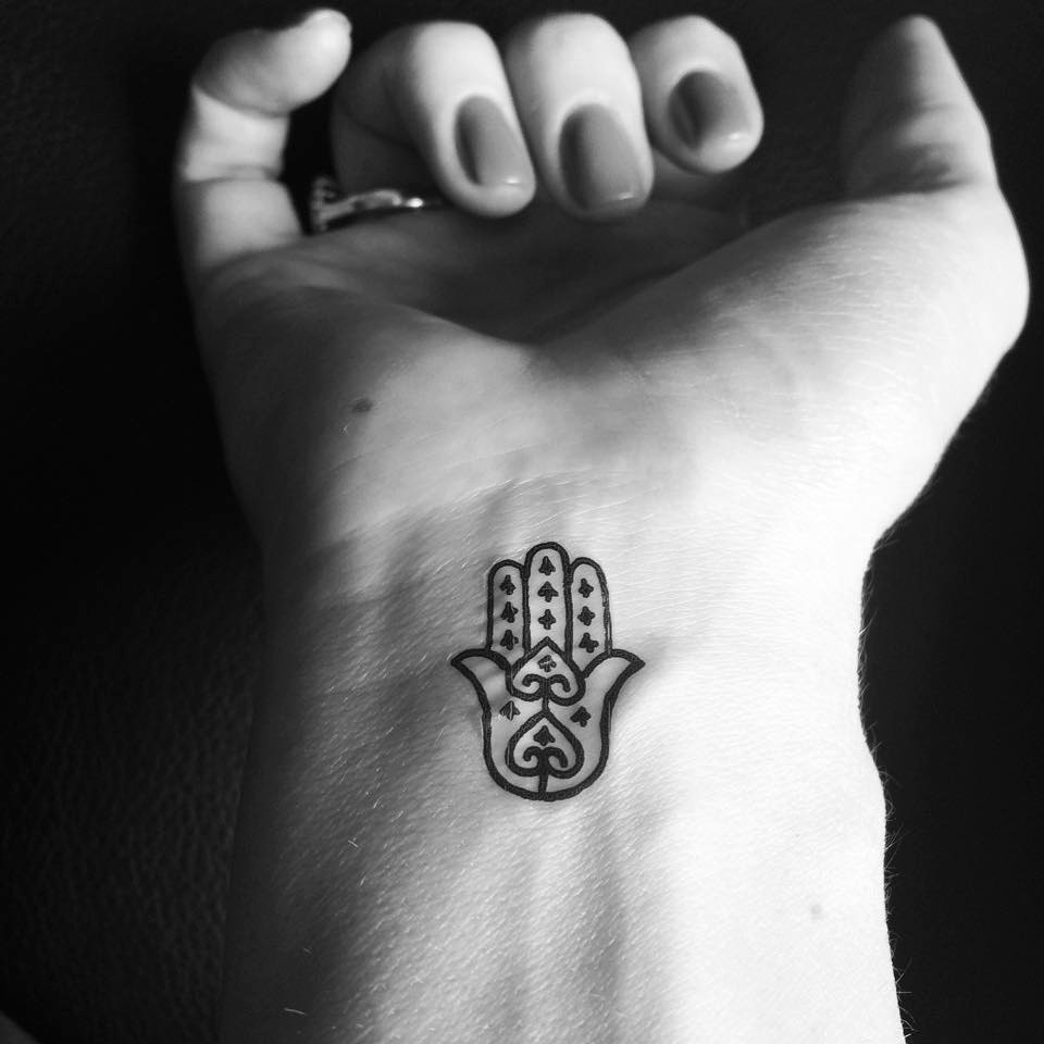 Simple Black Outline Hamsa Tattoo On Girl Right Wrist