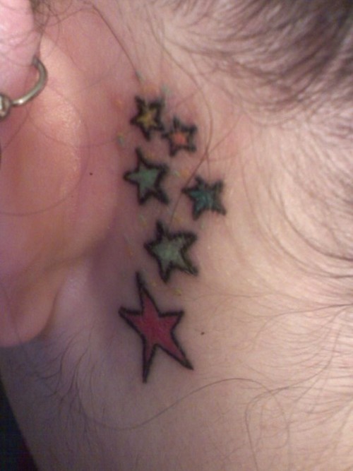 Simple Colorful Stars Tattoo On Left Behind The Ear