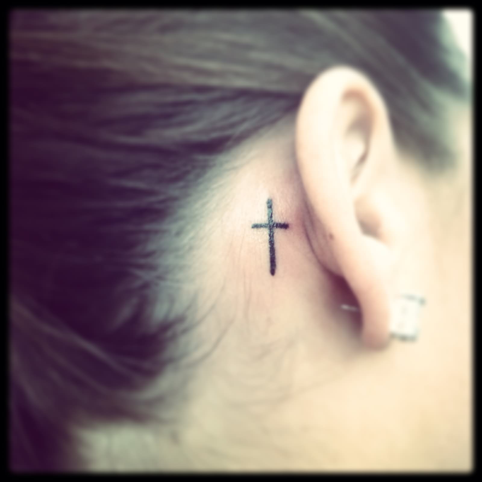 Simple Cross Tattoo On Girl Right Behind The Ear