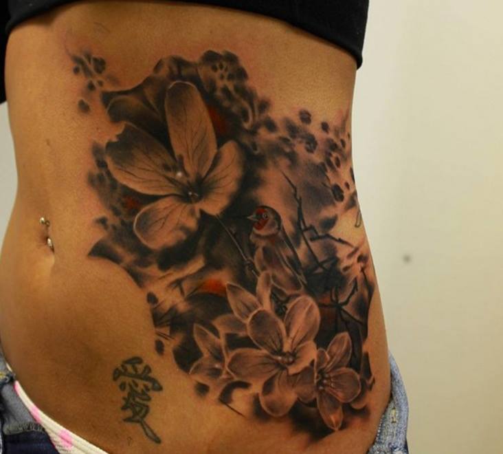 Small Sparrow In Flowers Tattoo On Hip by Gary Mossman