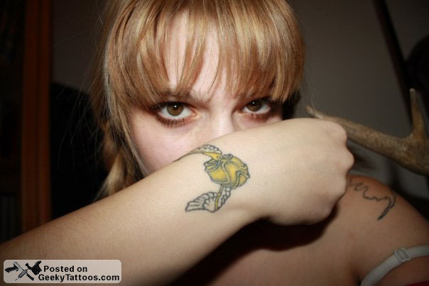 Snitch Tattoo On Girl Right Upper Wrist