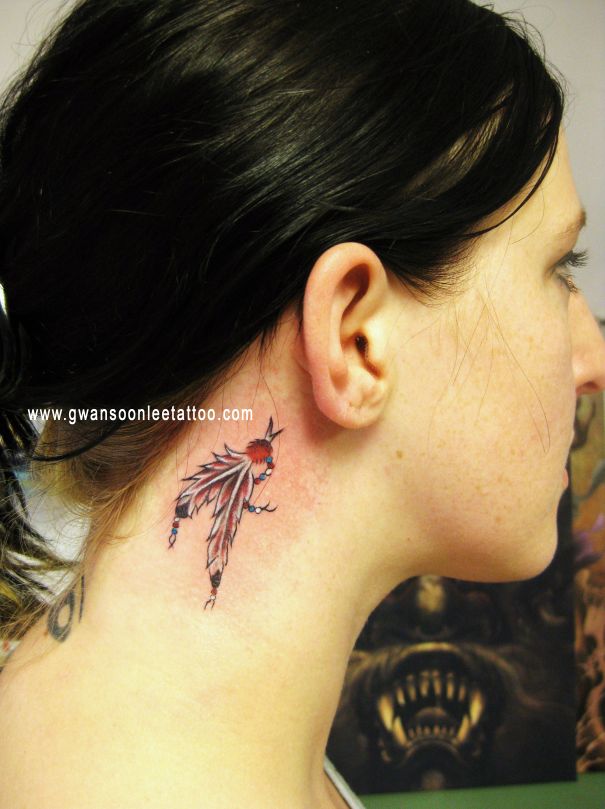 Traditional Feathers Tattoo On Girl Right Behind The Ear