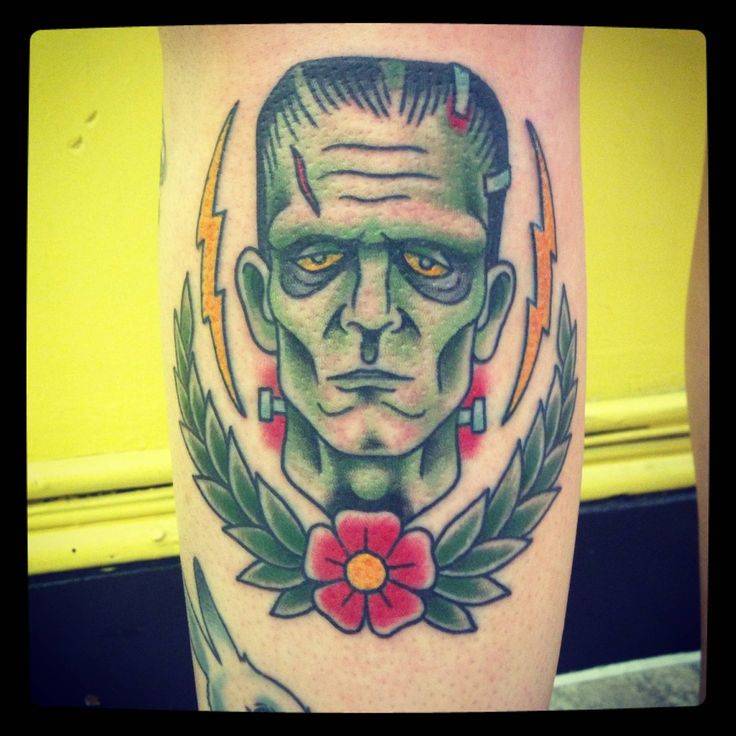 Traditional Frankenstein Head With Flower Tattoo Design For Leg Calf