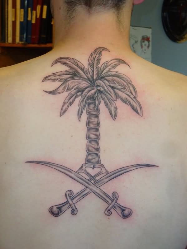 Two Swords And Palm Tree Tattoo On Upper Back